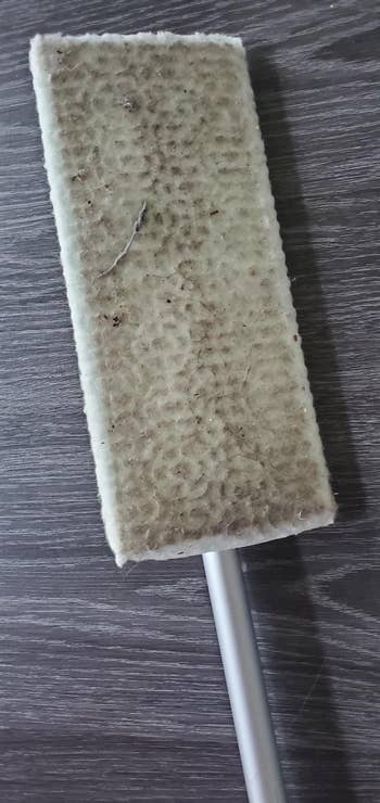 reviewer photo of the Swiffer pad with dirt on it