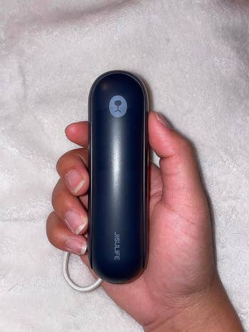 image of reviewer holding the closed portable fan