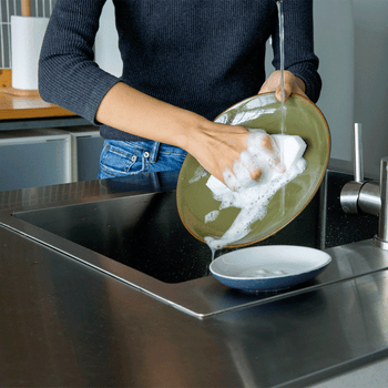 a gif of a model using the sponge to wash a dish 