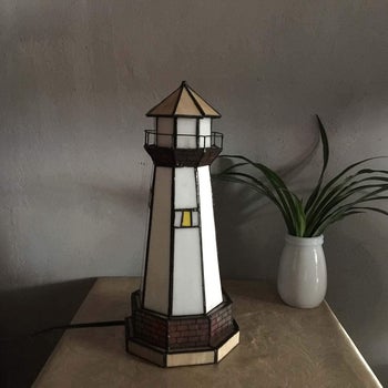 lighthouse shaped lamp made of stained glass, turned off