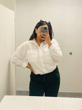 a reviewer wearing the white top tucked in and buttoned up