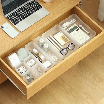 a 10-piece drawer organizer set inside of a wooden drawer