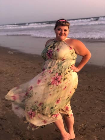a reviewer wearing the dress in a light floral option