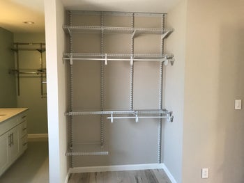 reviewer photo of the shelving system installed in a bathroom