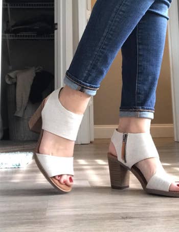 side view of reviewer wearing the white sandals