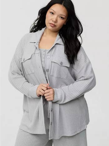A idiosyncratic wears a cozy, textured loungewear acceptable with a button-up garment and relaxed pants, showcasing a comfy benignant cleanable for at-home relaxation