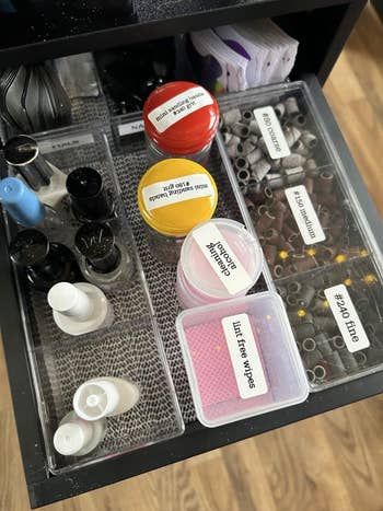bottles, jars, lint-free wipes, and sanding bands labeled by grit size