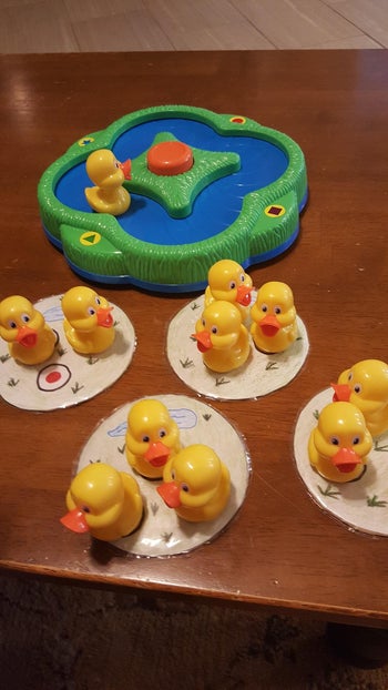 Reviewer image of plastic pond-shaped game board with plastic ducks