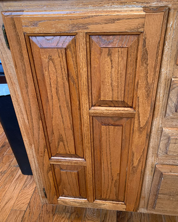 the same kitchen cabinet now looking brand new after using the wood polish