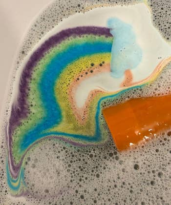 Rainbow bath weaponry  dissolving successful  water, creating colorful swirls and bubbles