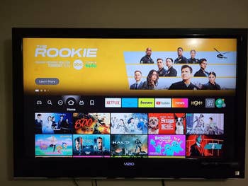 TV home screen displaying streaming apps with a featured ad for 