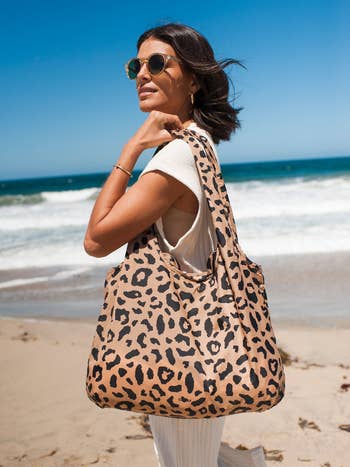 model holding the cheetah-print tote bag