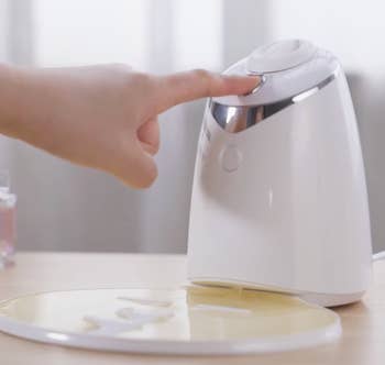 person making a face mask with the machine