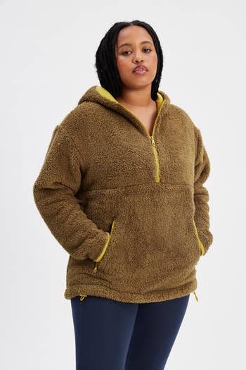 model wearing the green fleece hoodie