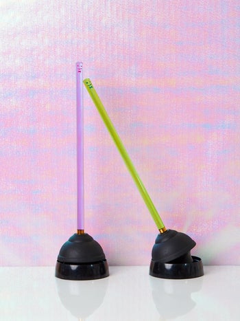 plungers with neon handles and a black base