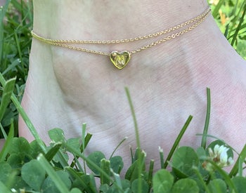 Reviewer wearing the initial anklet with the letter 
