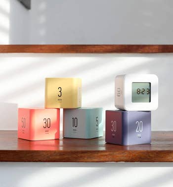 five of the cube timers in assorted colors