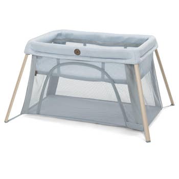 Portable babe playpen with mesh sides and a zippered opening, designed for casual setup and question convenience