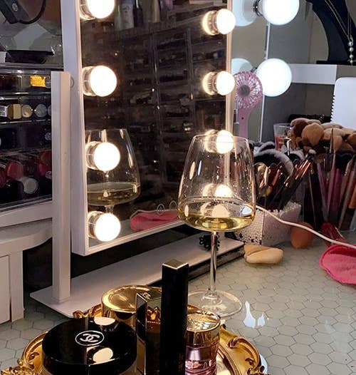 various fragrances and makeup on the gold mirror