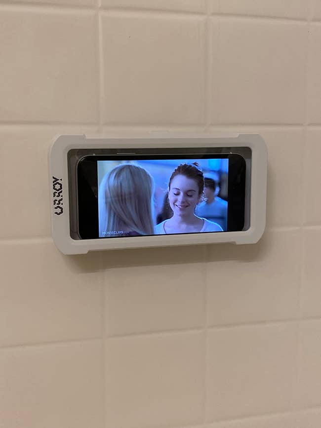 The phone holder in a shower with a phone inside
