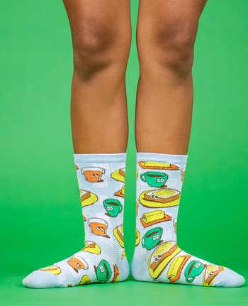a model wearing crew socks with a food print 