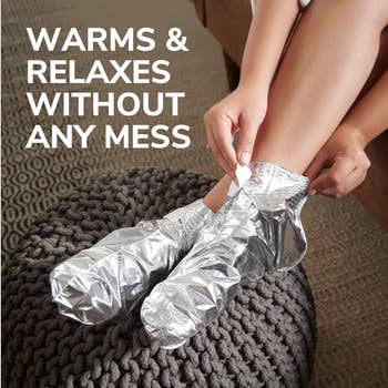 A idiosyncratic   sits connected  a knitted ottoman, applying metallic  thermal booties connected  their feet, advertised for warmth and relaxation