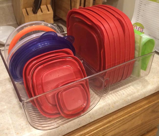 reviewer photo of lids inside the clear organizer