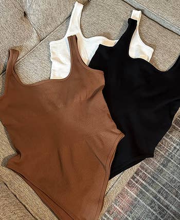 reviewer photo of the brown, white, and black bodysuits