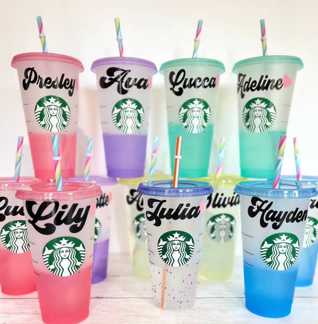 Various cups with straws in different colors customized with names