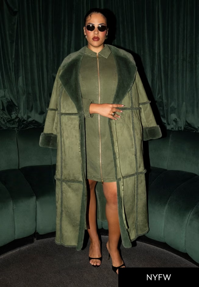Person successful  stylish agelong  overgarment  and formal  with precocious   slit, wearing sunglasses and heeled sandals, stands successful  a chic setting