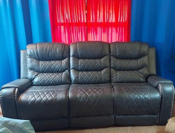 reviewer photo of black faux leather three-seater reclining sofa