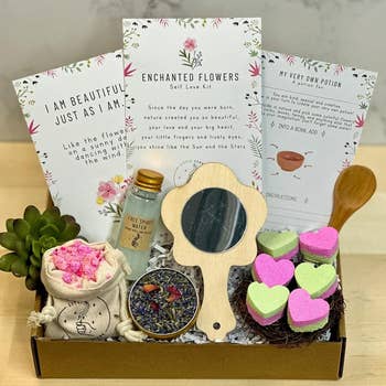  includes affirmations, herbal packets, a mini mirror, potion vial, and heart-shaped bath products, arranged neatly