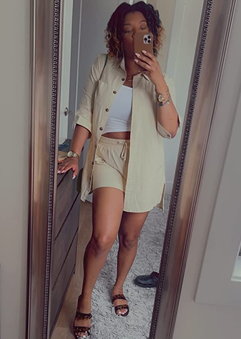 reviewer wearing the beige shorts set with a white top