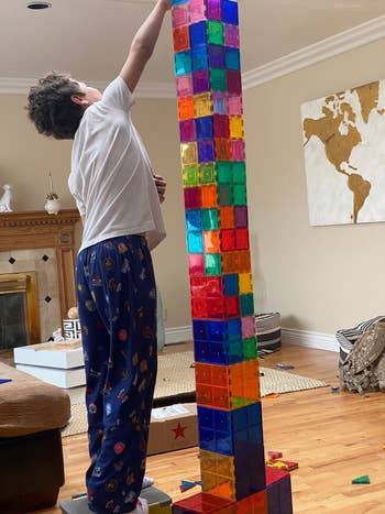 reviewer photo of a  child building a tower that's taller than them