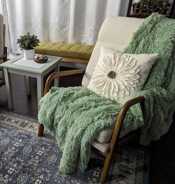 green throw draped onto arm of chair
