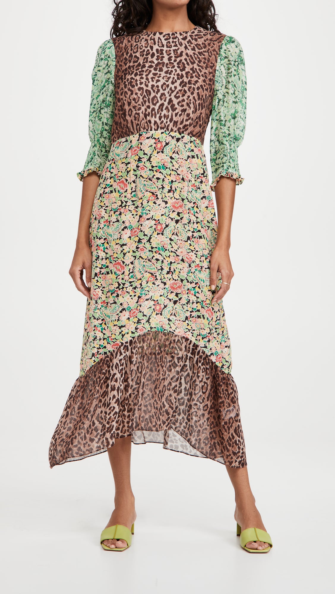 model in midi dress with leopard bodice and hemline, pink, black, and green floral skirt, and green floral three quarter sleeves