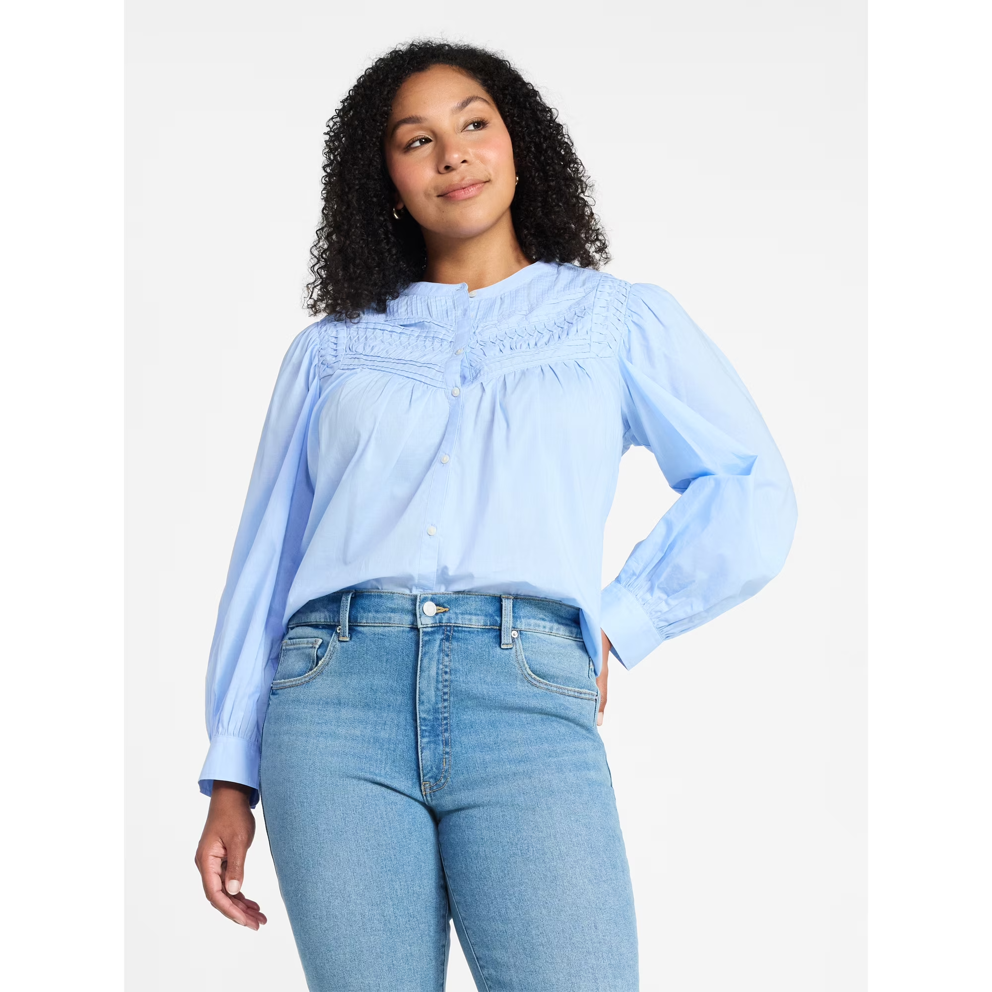 A idiosyncratic   is wearing a stylish button-up blouse with intricate detailing, paired with jeans, suitable for casual oregon  semi-casual occasions