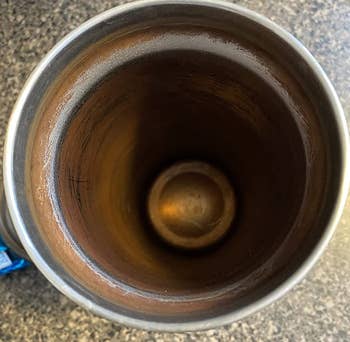 reviewer before image of the inside of a stainless steel bottle covered in rust and stains