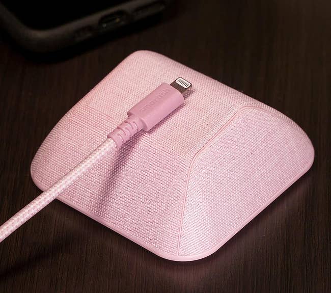 a pink gadget that magnetically holds wires in place