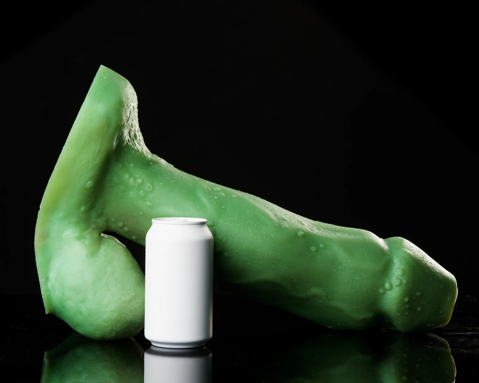 Dildo next to soda can to demonstrate size