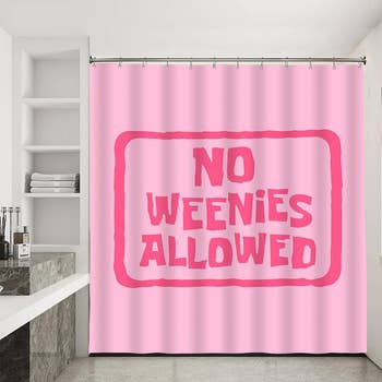 pink shower curtain with bold text 