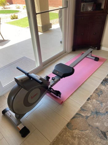 reviewer photo of the rowing machine on a pink mat