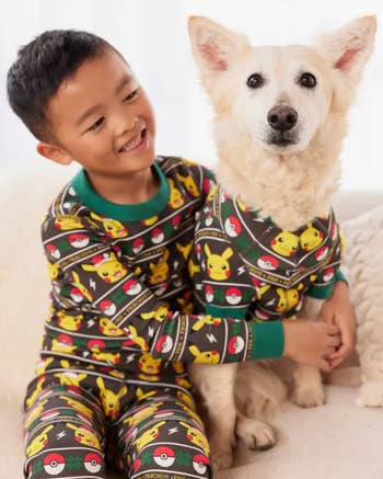 a child and a dog in pikachu holiday pajamas