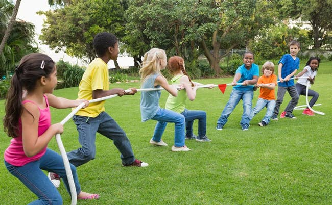 children playing tug of war outside
