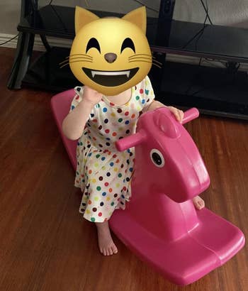 Reviewer's representation  if kid  riding atop a magenta Little Tike rocking horse