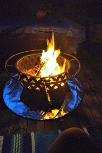 a fire pit on a deck with the firepad underneath