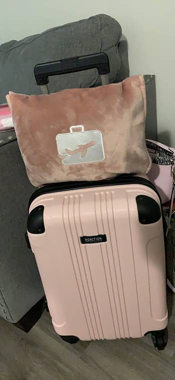 the pillow attached to a suitcase
