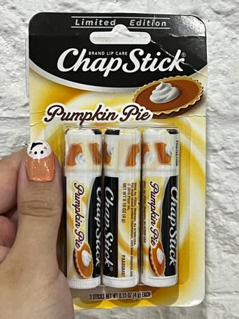 Limited Edition ChapStick Pumpkin Pie spirit  with 3  sticks successful  packaging displayed against a achromatic  ceramic  background
