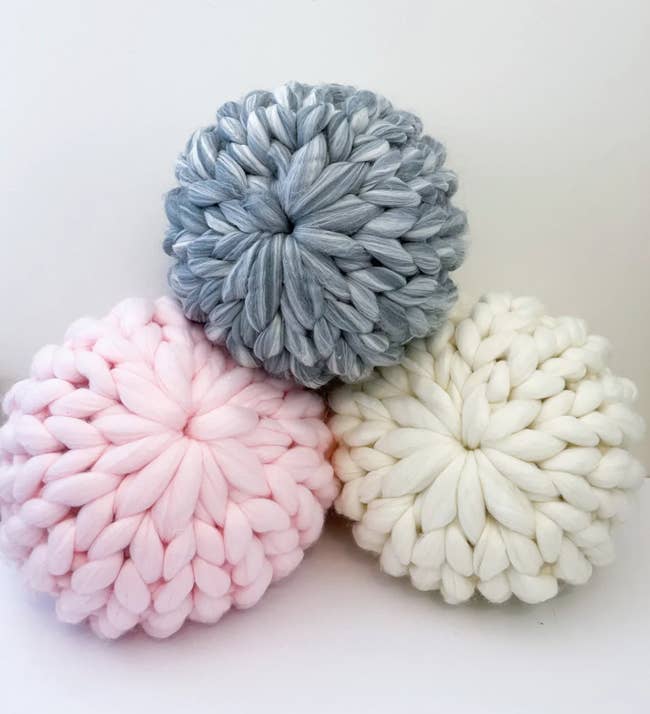 Pink, gray, and white knitted pillows