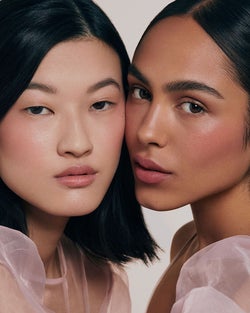 two models wearing the multi stick on their face